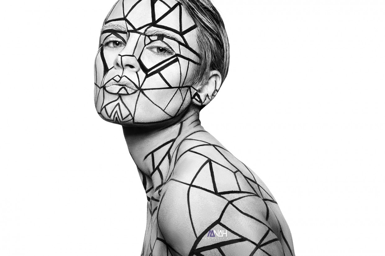 Understanding tattoo trends is an important step in your journey towards a tattoo career, but it can also be pretty eye-opening to how difficult tattooing can be. Without the right knowledge, it’s impossible to level up your skills as a professional tattoo artist. However, finding the straight-forward information you need to progress is difficult. And with so much out there online, it’s hard to avoid picking up bad habits from incorrect and outdated resources. This is one of the biggest struggles new tattooers face, and too many talented artists have given up their goal of getting into tattooing because of the years it would take to unlearn their bad habits. That’s why aspiring artists are learning to tattoo with the Artist Accelerator Program’s structured course. As a student, you learn every step of the tattooing process from tattoo artists with the experience and advice you need for your tattoo career. With the Artist Accelerator, you can stop wasting time searching through incorrect information. You just get the clear, easy-to-understand lessons you need to start improving fast… along with support and personalized feedback from professional artists in our online Mastermind group. Over 2500 students have already gone through the course, with many of them opening up their own studios. If you want to join them and learn the skills you need to start tattooing full time faster… Model with temporary tattoo lines across her body and face