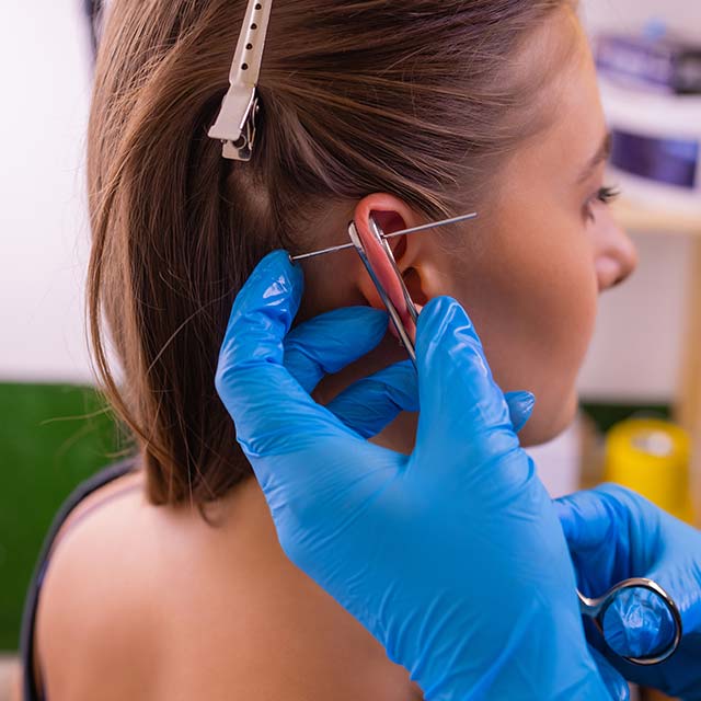 ear piercing at a tattoo parlor