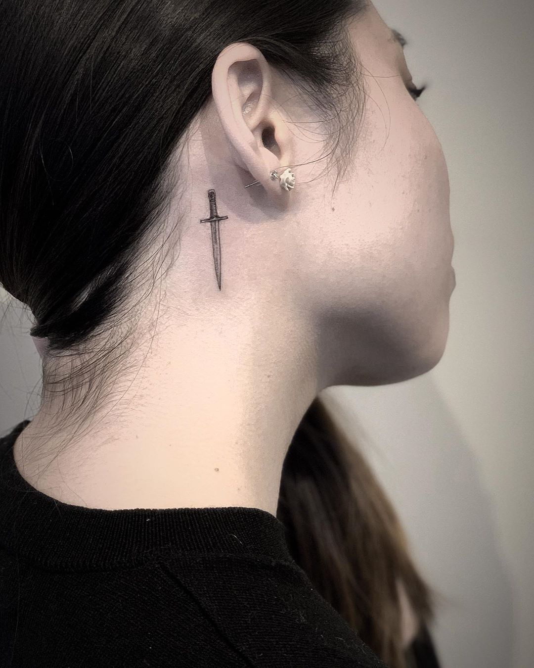 tumblr_173799c8c1dfea2d7147285377192065_097ee3ff_1280 behind the ear dagger tattoo in black ink