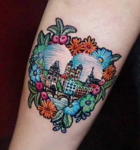 Embroidery tattoo design of a cityscape Embroidery tattoo design of a cityscape within a heart surrounded by flowers