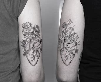 Flowers growing from an anatomical hearty Fine line tattoo of flowers growing from an anatomical hearty
