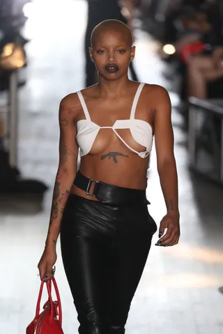 Model with tattoos on runway Model with tattoos on runway