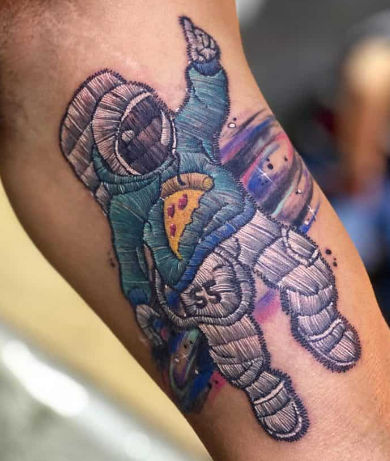 Patch tattoo of an astronaut Patch tattoo of an astronaut wearing a hoodie with a slice of pizza on the front