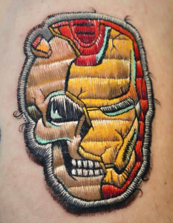 Patch tattoo of Iron Man’s mask Patch tattoo of Iron Man’s mask breaking open to reveal a skull