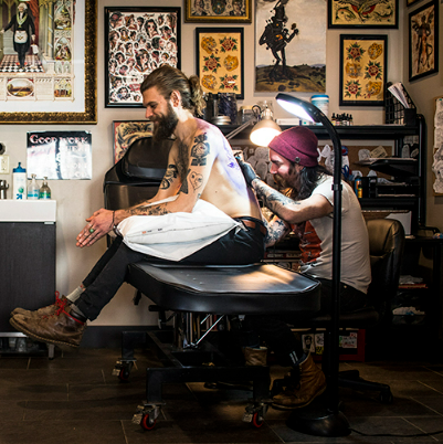 professional tattoo artist working professional tattoo artist working in a tattoo studio