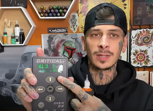 professional tattoo artist professional artist holding a tattoo power supply