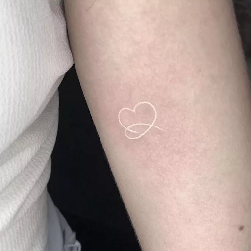 Subtle white ink tattoos