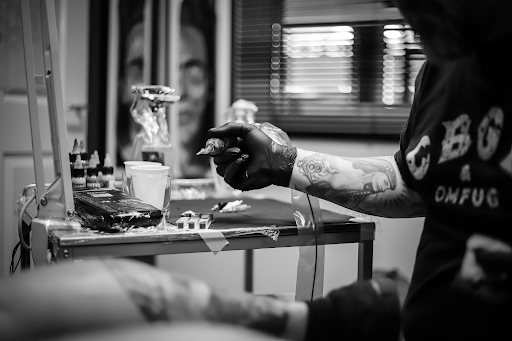 Tattoo artist holding tattoo machine