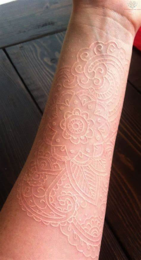tattoo with white ink on pale skin