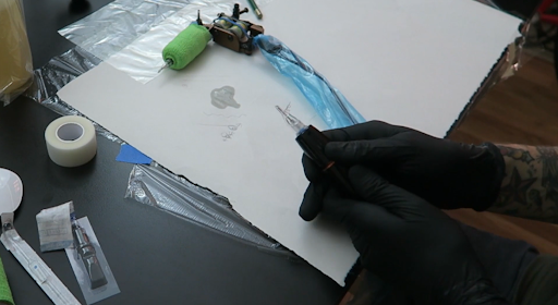 training a tattoo student training a tattoo student